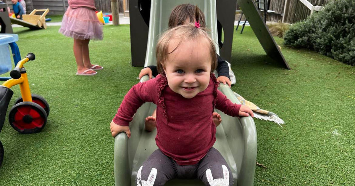 smiling baby on the slide