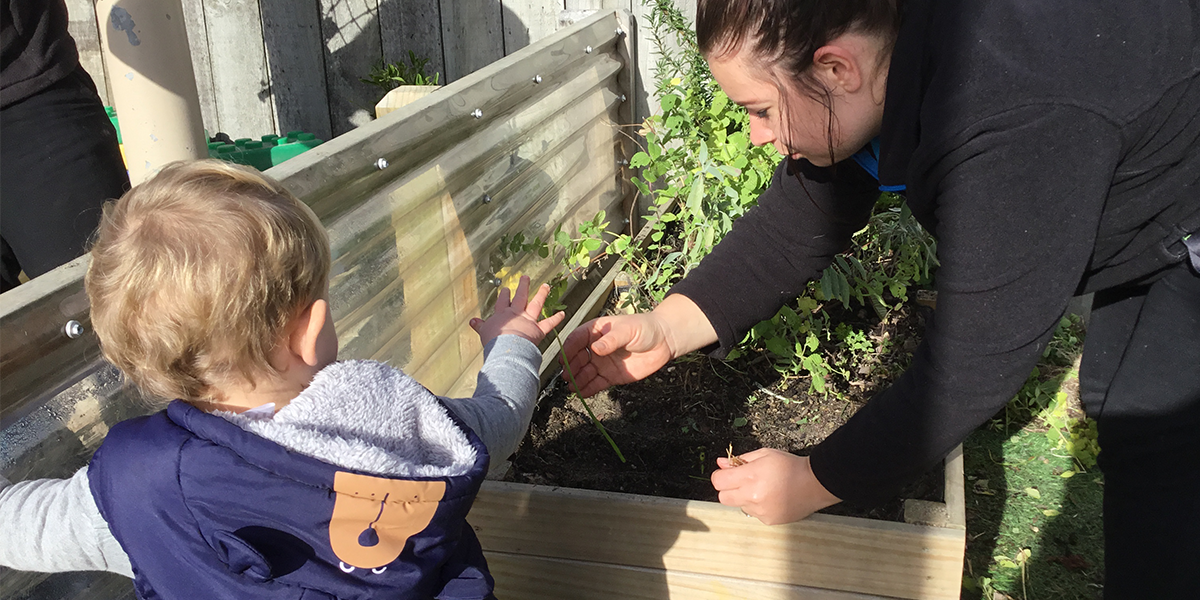 Motutaiko-childcare-gardenteacherstanding