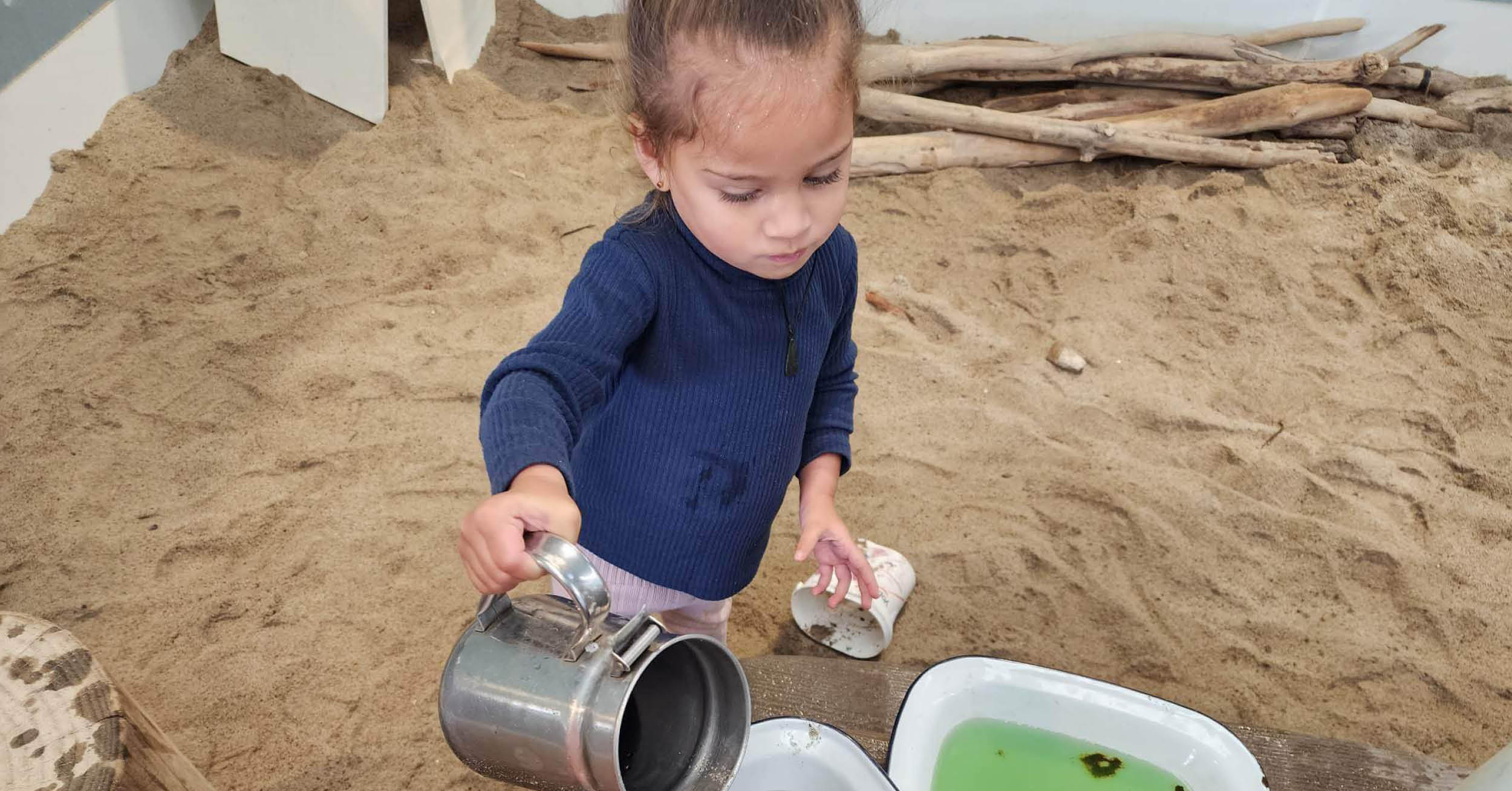 1696806445kid in sand with cup Oct2023.jpg
