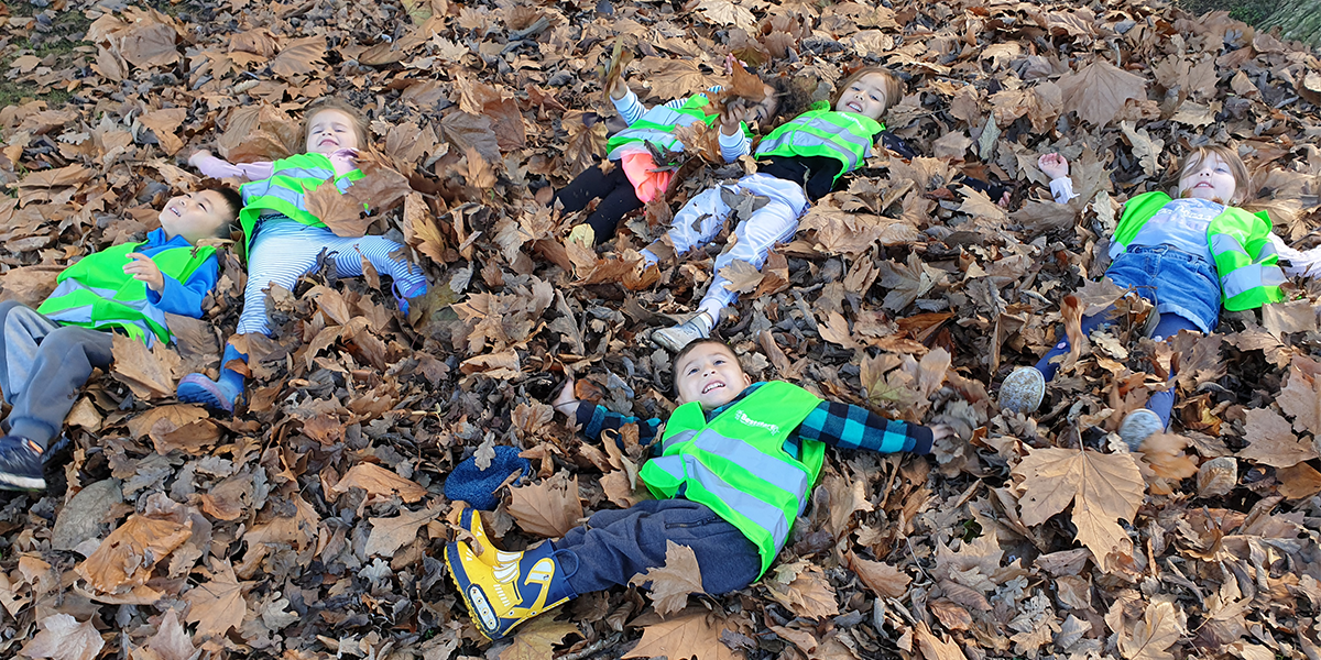 children lying in the leaves